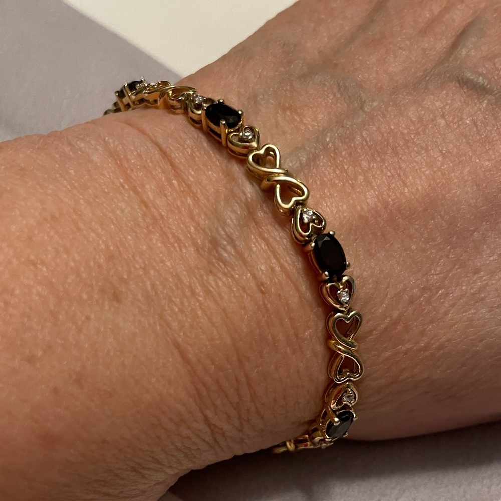 Gold Tone Bracelet with Heart Designs, CZ and Garnet Colored Stones